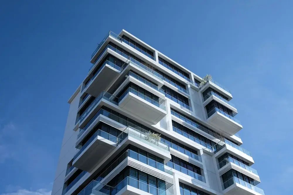 Modern apartment tower against a blue sky