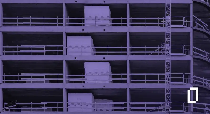 Built environment emissions: concrete frame of a multi-storey building under construction, with a purple wash