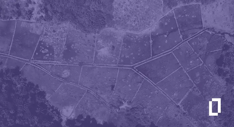 Land-intensive company emissions: aerial view of small farm plots bordered by forest, under a purple wash with the Terrascope logomark