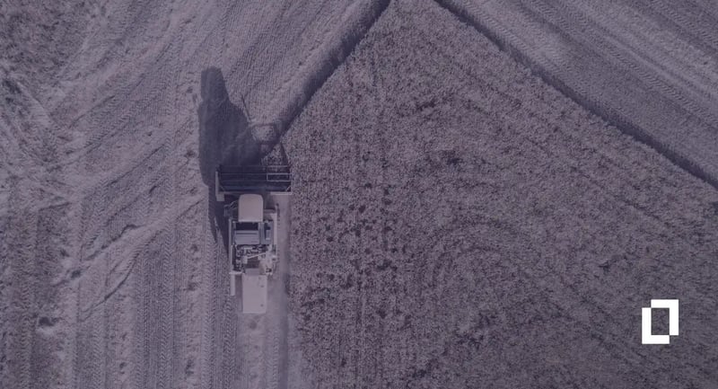 Agri-food carbon accounting platforms: aerial view of a combine harvester cutting a grain field