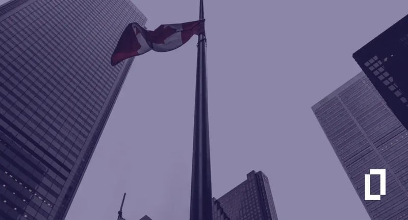 Canada climate disclosure rules: Canadian flag among bank towers in Toronto's financial district