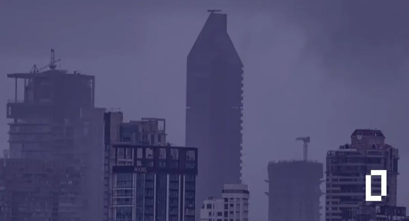 India climate disclosure rules: Mumbai high-rise towers under heavy monsoon clouds