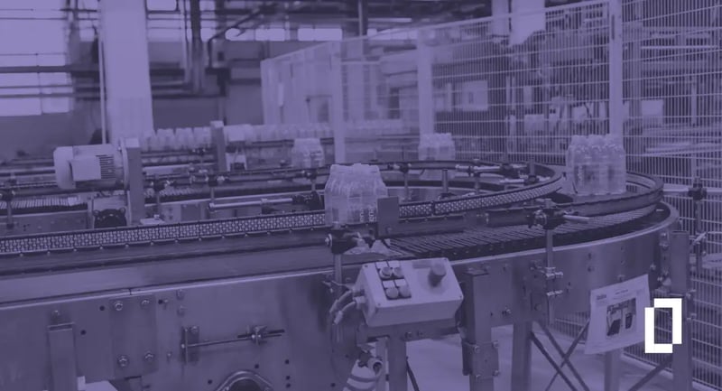 Product carbon footprint software: packs of bottled water on a curved conveyor in a beverage bottling plant