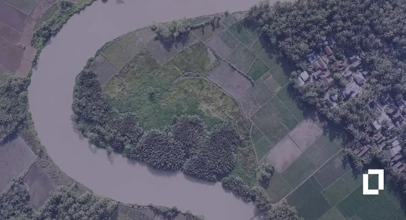 Watershed alternatives for food supply chains: aerial view of a river winding past farm plots and woodland