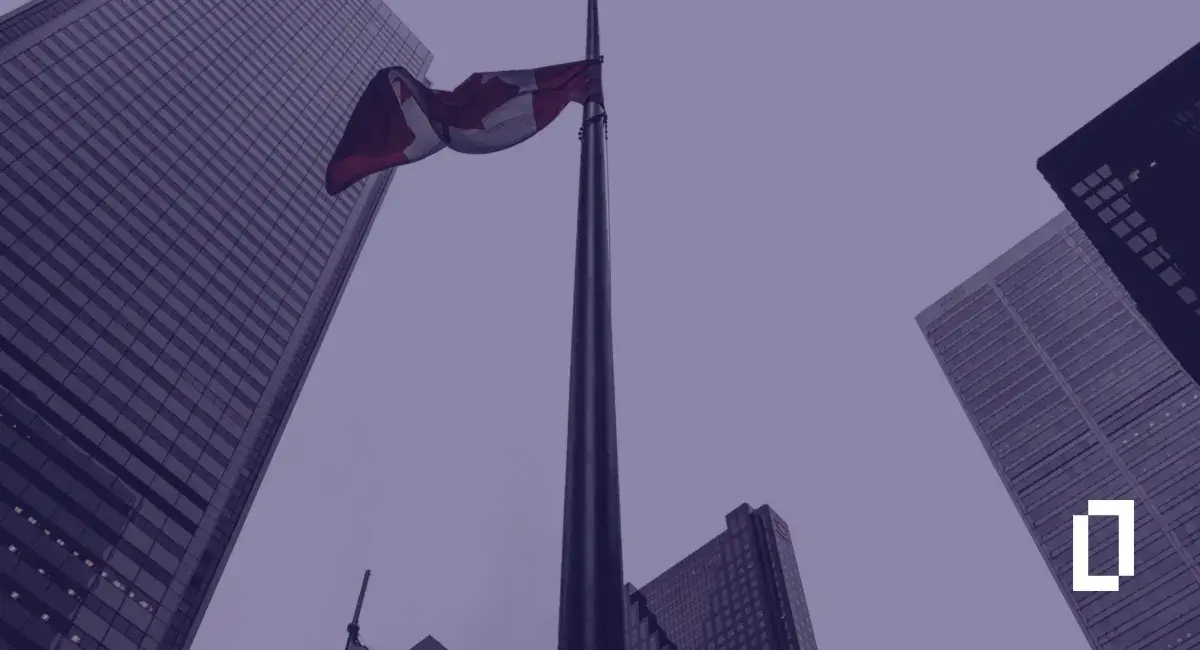 Canada climate disclosure rules: Canadian flag among bank towers in Toronto's financial district