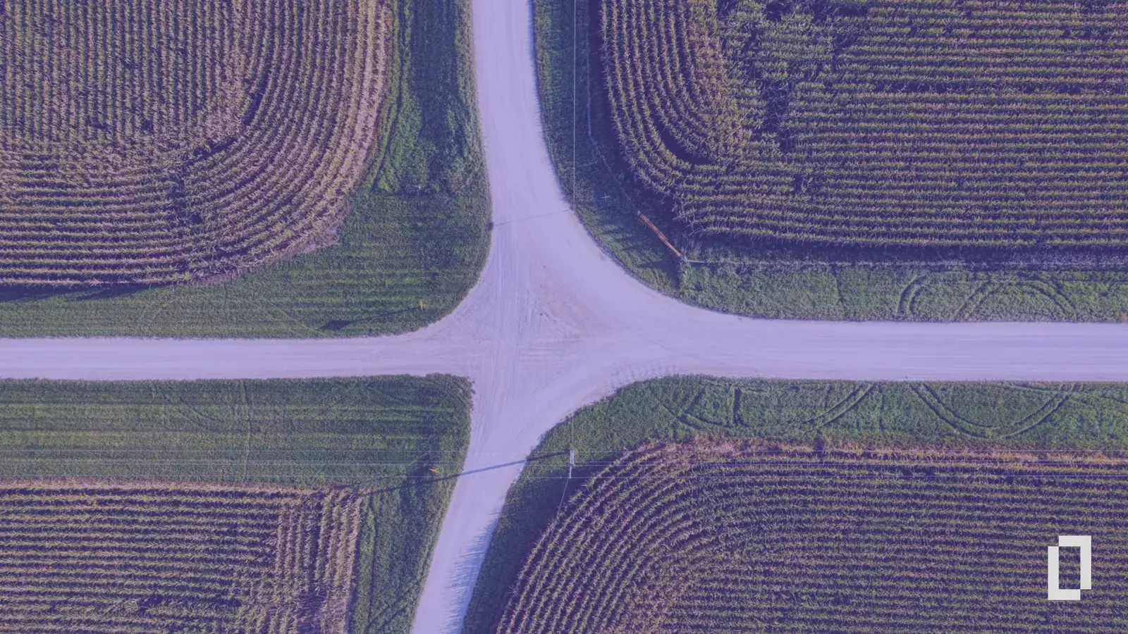 Aerial view of a crossroads between farm fields, with a purple tint and the Terrascope logo: four routes to a carbon footprint.