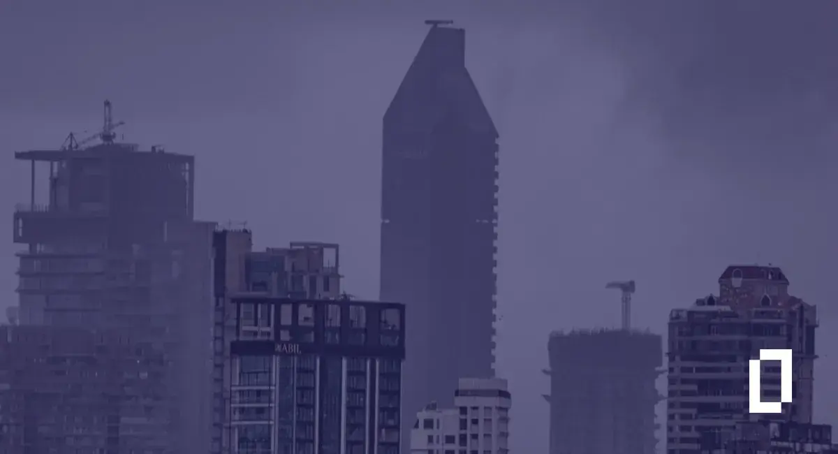India climate disclosure rules: Mumbai high-rise towers under heavy monsoon clouds