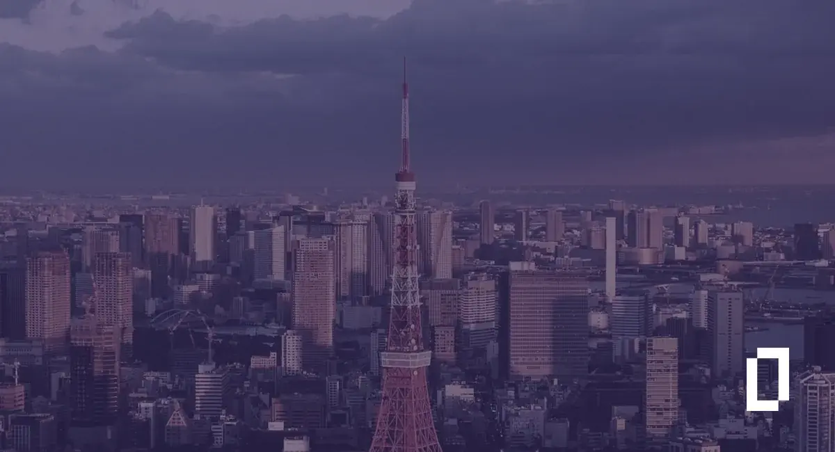 Japan climate disclosure rules: Tokyo Tower rising above the Tokyo skyline at dusk